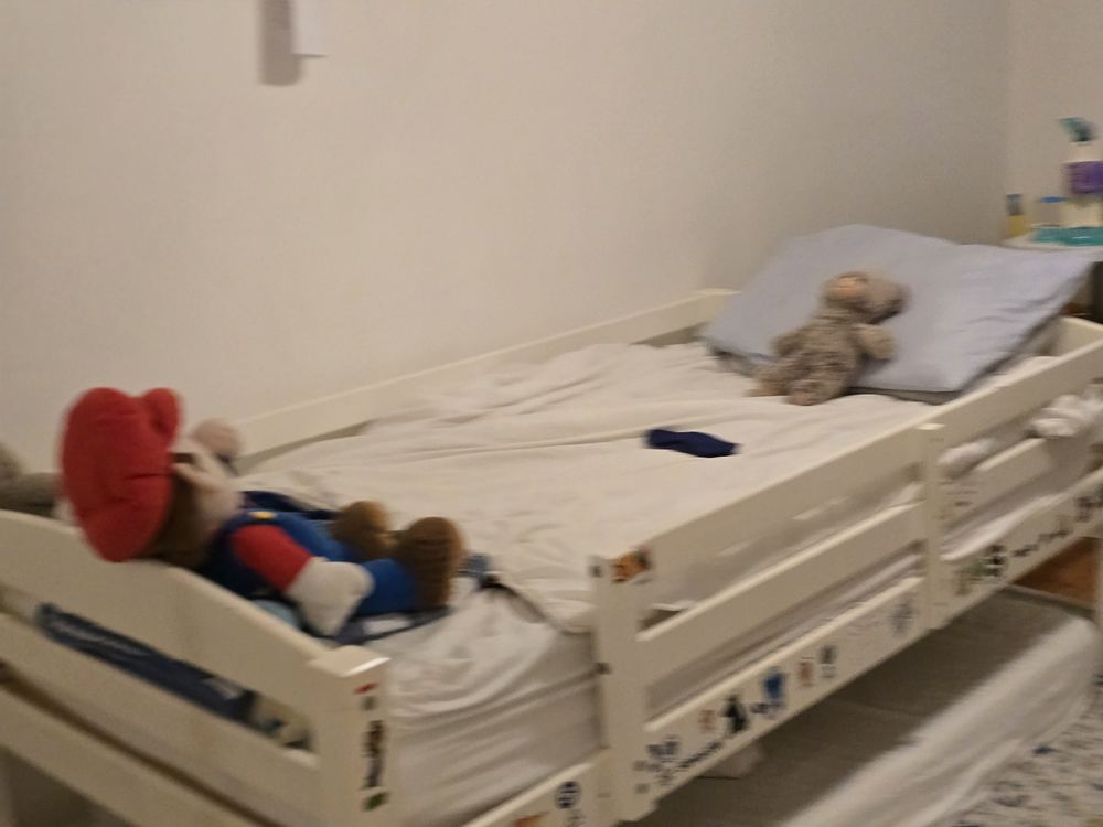 The bunk bed in the Kids Suite with a teddy bear and a stuffed Mario