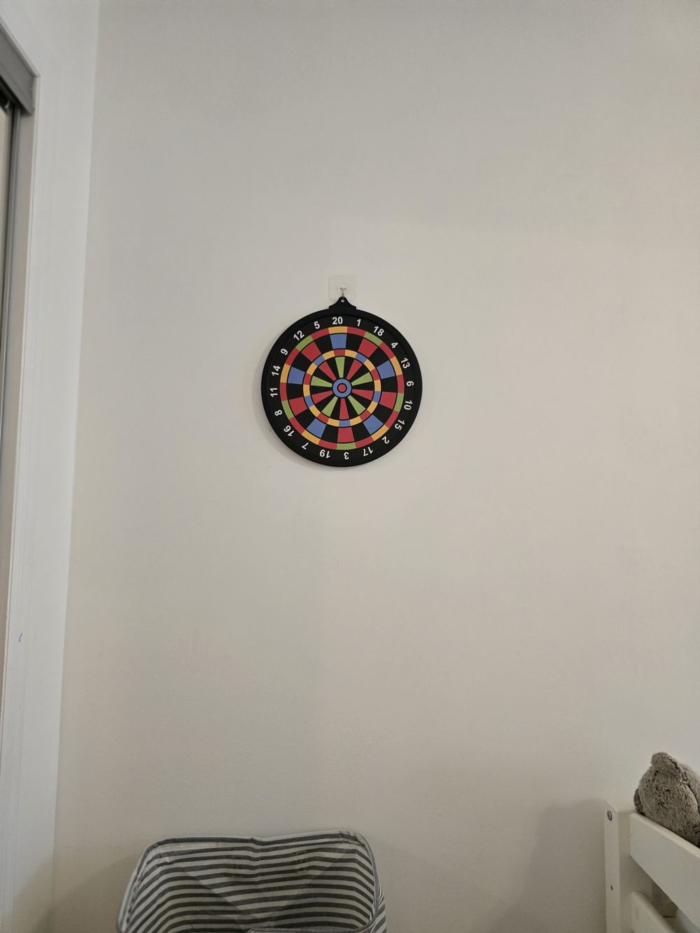 A dartboard hanging on the wall of the Kids Suite