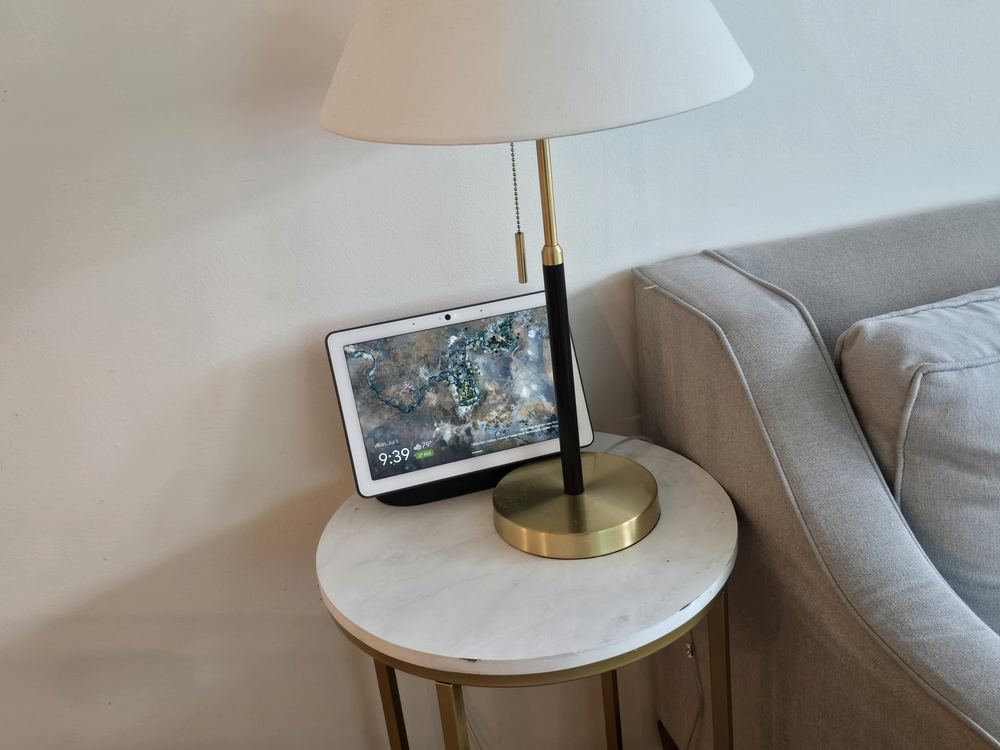 A cozy side table with a lamp next to the lounge sofa